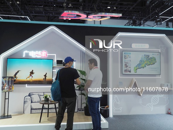 Visitors visit the ''5G Home Video System'' at the booth of China Broadcasting and Television at the 2024 China International Information an...