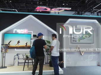 Visitors visit the ''5G Home Video System'' at the booth of China Broadcasting and Television at the 2024 China International Information an...