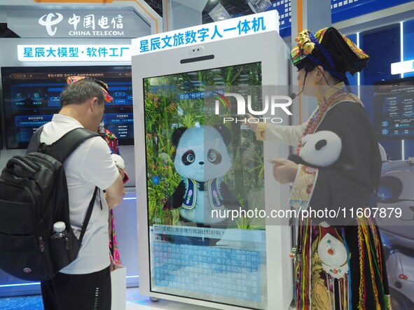 Visitors interact with ''Cultural Travel Digital People'' at the booth of China Telecom at the 2024 China International Information and Comm...