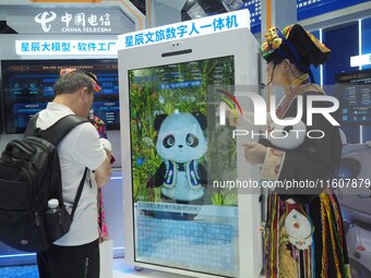 Visitors interact with ''Cultural Travel Digital People'' at the booth of China Telecom at the 2024 China International Information and Comm...