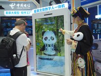 Visitors interact with ''Cultural Travel Digital People'' at the booth of China Telecom at the 2024 China International Information and Comm...