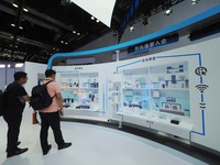 Visitors examine broadband network equipment at the booth of Sintech at the 2024 China International Information and Communications Exhibiti...