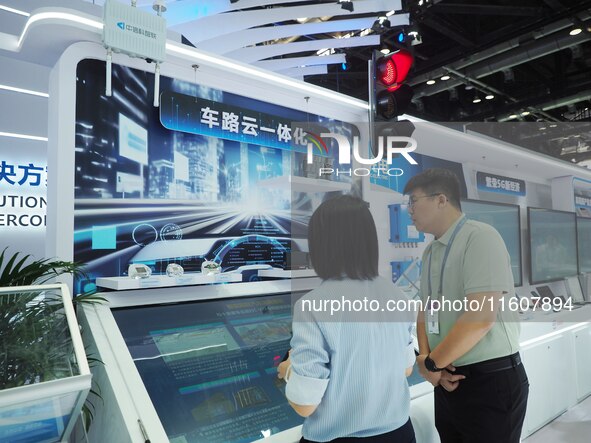 Visitors visit the ''Vehicle, Road and Cloud Integration System'' at the booth of Sintech at the 2024 China International Information and Co...