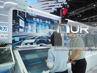 Visitors visit the ''Vehicle, Road and Cloud Integration System'' at the booth of Sintech at the 2024 China International Information and Co...