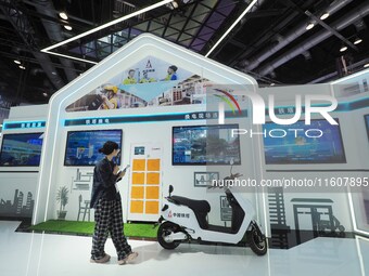 Visitors visit the ''Energy Saving and Carbon Reduction'' section of the China Tower booth at the 2024 China International Information and C...