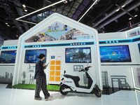 Visitors visit the ''Energy Saving and Carbon Reduction'' section of the China Tower booth at the 2024 China International Information and C...