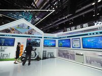 Visitors visit the ''Energy Saving and Carbon Reduction'' section of the China Tower booth at the 2024 China International Information and C...