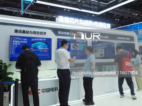 Visitors visit ''Communication Chips and Components'' at the 2024 China International Information and Communication Exhibition in Beijing, C...