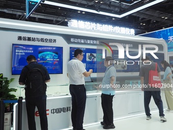 Visitors visit ''Communication Chips and Components'' at the 2024 China International Information and Communication Exhibition in Beijing, C...