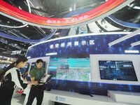 Visitors visit the ''5G+ Connected drone'' at the booth of China Mobile at the 2024 China International Information and Communications Exhib...