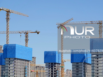 Tower cranes are seen at a real estate construction site in Beijing, China, on September 12, 2024. On September 24, 2024, the press conferen...