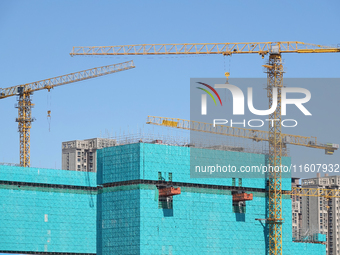 Tower cranes are seen at a real estate construction site in Beijing, China, on September 12, 2024. On September 24, 2024, the press conferen...