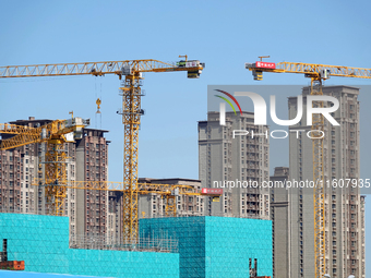 Tower cranes are seen at a real estate construction site in Beijing, China, on September 12, 2024. On September 24, 2024, the press conferen...