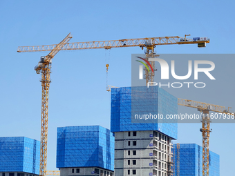 Tower cranes are seen at a real estate construction site in Beijing, China, on September 12, 2024. On September 24, 2024, the press conferen...