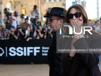 Monica Bellucci and Tim Burton arrive at the Maria Cristina Hotel during the 72nd San Sebastian International Film Festival in San Sebastian...