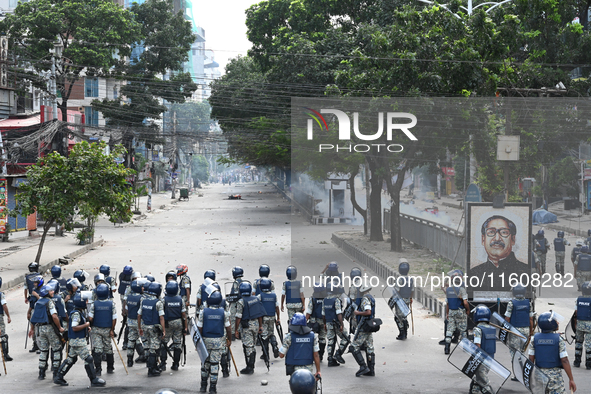 A Bangladeshi policeman fires a rubber bullet to disperse anti-quota protesters during a clash at Uttara in Dhaka, Bangladesh, on July 19, 2...