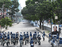 A Bangladeshi policeman fires a rubber bullet to disperse anti-quota protesters during a clash at Uttara in Dhaka, Bangladesh, on July 19, 2...