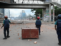 A Bangladeshi policeman fires a rubber bullet to disperse anti-quota protesters during a clash at Uttara in Dhaka, Bangladesh, on July 19, 2...