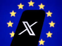 European Union flag displayed on a laptop screen and X logo displayed on a phone screen are seen in this illustration photo taken in Krakow,...