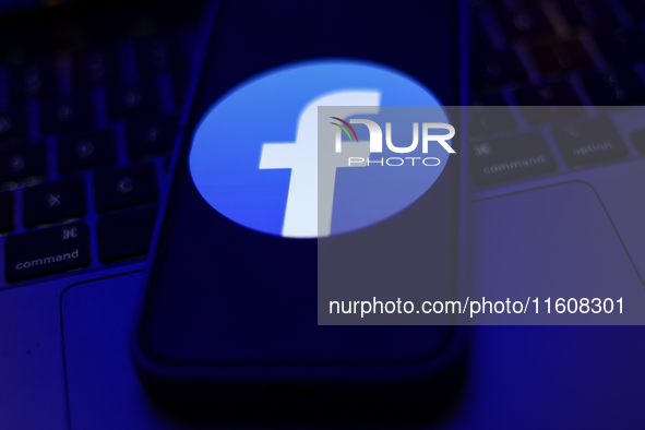 Facebook logo displayed on a phone screen and a laptop keyboard are seen in this illustration photo taken in Krakow, Poland on September 25,...