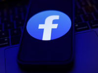 Facebook logo displayed on a phone screen and a laptop keyboard are seen in this illustration photo taken in Krakow, Poland on September 25,...