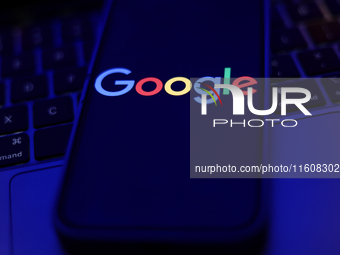 Google logo displayed on a phone screen and a laptop keyboard are seen in this illustration photo taken in Krakow, Poland on September 25, 2...