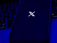 X logo displayed on a phone screen and a laptop keyboard are seen in this illustration photo taken in Krakow, Poland on September 25, 2024....