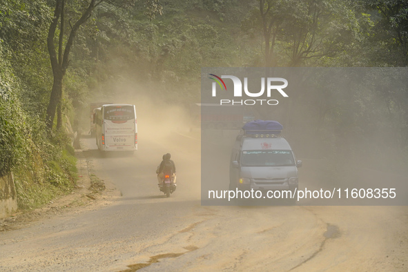 Due to the expansion of Prithvi Highway, passengers suffer from dust pollution while traveling on Prithvi Highway in Dhading, Nepal, on Sept...