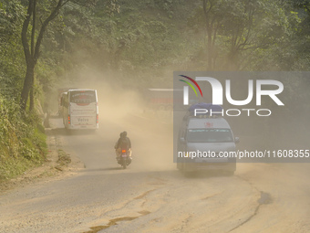 Due to the expansion of Prithvi Highway, passengers suffer from dust pollution while traveling on Prithvi Highway in Dhading, Nepal, on Sept...