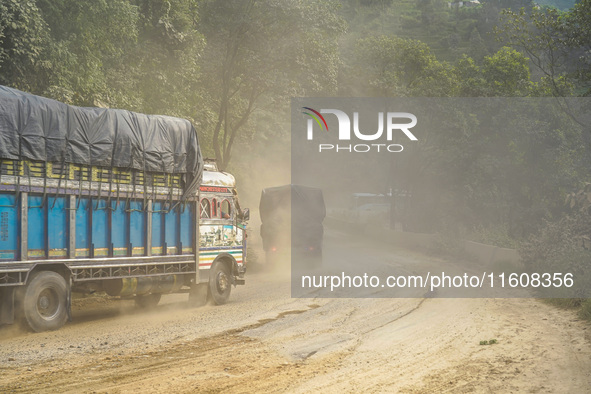 Due to the expansion of Prithvi Highway, passengers suffer from dust pollution while traveling on Prithvi Highway in Dhading, Nepal, on Sept...