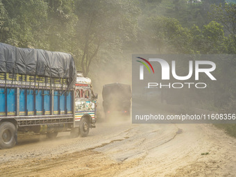 Due to the expansion of Prithvi Highway, passengers suffer from dust pollution while traveling on Prithvi Highway in Dhading, Nepal, on Sept...