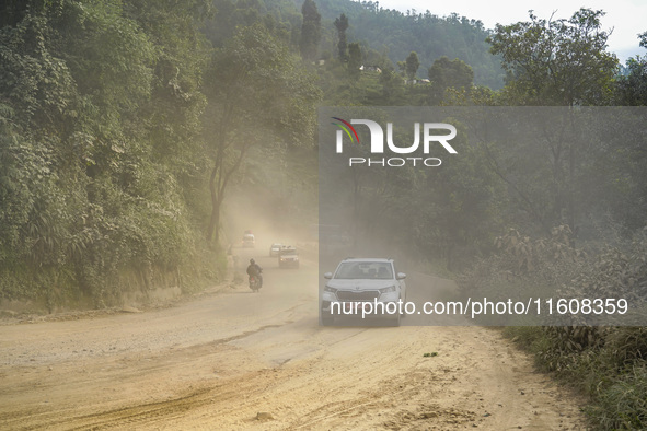 Due to the expansion of Prithvi Highway, passengers suffer from dust pollution while traveling on Prithvi Highway in Dhading, Nepal, on Sept...