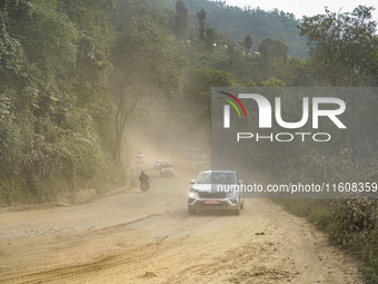 Due to the expansion of Prithvi Highway, passengers suffer from dust pollution while traveling on Prithvi Highway in Dhading, Nepal, on Sept...