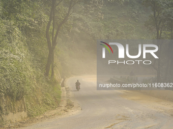 Due to the expansion of Prithvi Highway, passengers suffer from dust pollution while traveling on Prithvi Highway in Dhading, Nepal, on Sept...