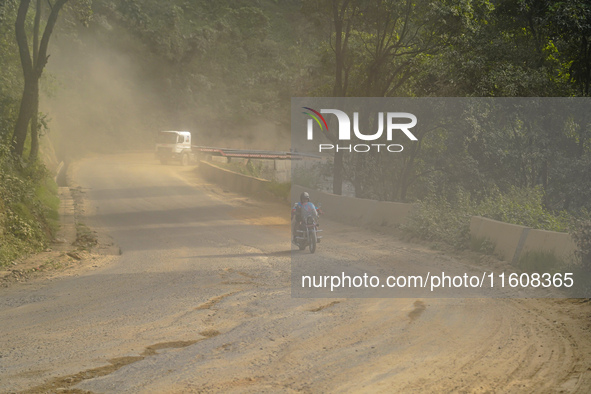 Due to the expansion of Prithvi Highway, passengers suffer from dust pollution while traveling on Prithvi Highway in Dhading, Nepal, on Sept...