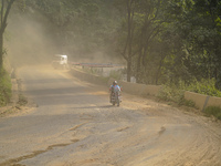 Due to the expansion of Prithvi Highway, passengers suffer from dust pollution while traveling on Prithvi Highway in Dhading, Nepal, on Sept...