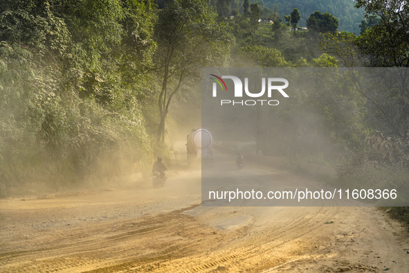 Due to the expansion of Prithvi Highway, passengers suffer from dust pollution while traveling on Prithvi Highway in Dhading, Nepal, on Sept...