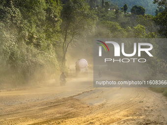 Due to the expansion of Prithvi Highway, passengers suffer from dust pollution while traveling on Prithvi Highway in Dhading, Nepal, on Sept...