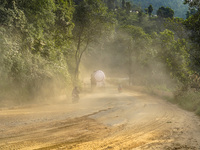 Due to the expansion of Prithvi Highway, passengers suffer from dust pollution while traveling on Prithvi Highway in Dhading, Nepal, on Sept...