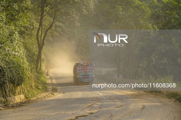 Due to the expansion of Prithvi Highway, passengers suffer from dust pollution while traveling on Prithvi Highway in Dhading, Nepal, on Sept...