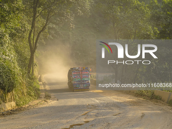 Due to the expansion of Prithvi Highway, passengers suffer from dust pollution while traveling on Prithvi Highway in Dhading, Nepal, on Sept...