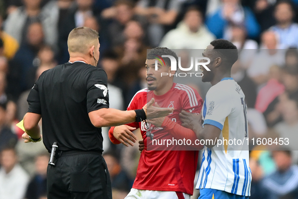 Referee Robert Jones speaks with Morgan Gibbs-White of Nottingham Forest during the Premier League match between Brighton and Hove Albion an...