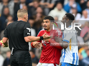 Referee Robert Jones speaks with Morgan Gibbs-White of Nottingham Forest during the Premier League match between Brighton and Hove Albion an...