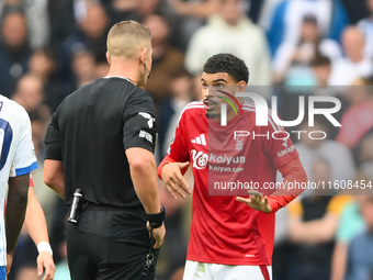 Referee Robert Jones speaks with Morgan Gibbs-White of Nottingham Forest during the Premier League match between Brighton and Hove Albion an...