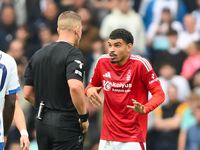 Referee Robert Jones speaks with Morgan Gibbs-White of Nottingham Forest during the Premier League match between Brighton and Hove Albion an...