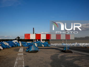 A street barrier and sand bags are seen on September 25, 2024 in an agricultural area near Nysa as massive flooding affected large agricultu...