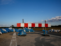 A street barrier and sand bags are seen on September 25, 2024 in an agricultural area near Nysa as massive flooding affected large agricultu...