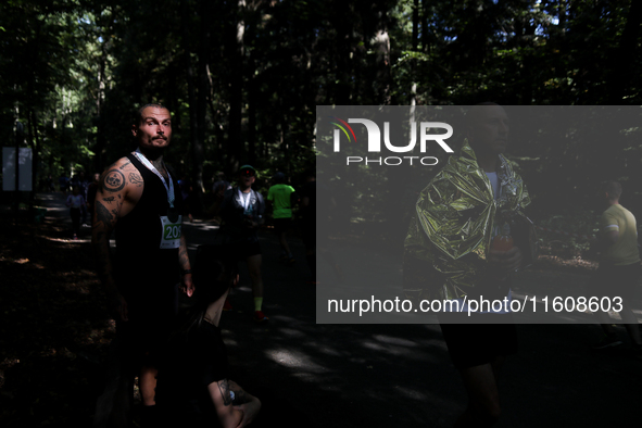 Athletes rest after running during the 17th PKO Three Mounds Run on Pilsudski Mound in Krakow, Poland, on September 22, 2024. The Three Moun...