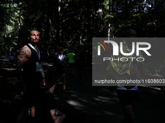 Athletes rest after running during the 17th PKO Three Mounds Run on Pilsudski Mound in Krakow, Poland, on September 22, 2024. The Three Moun...