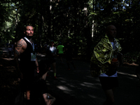 Athletes rest after running during the 17th PKO Three Mounds Run on Pilsudski Mound in Krakow, Poland, on September 22, 2024. The Three Moun...